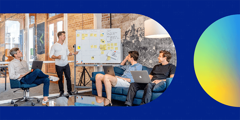 Design team having a meeting at a whiteboard.