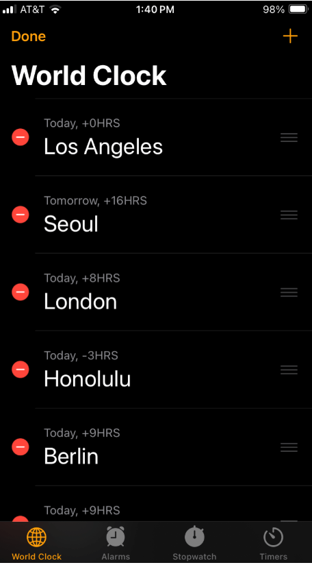 World Clock app in edit mode showing a list of cities with a bold red circular delete button next to each city name. The red colour creates strong contrast against the black background, signalling caution and emphasising the action’s importance.