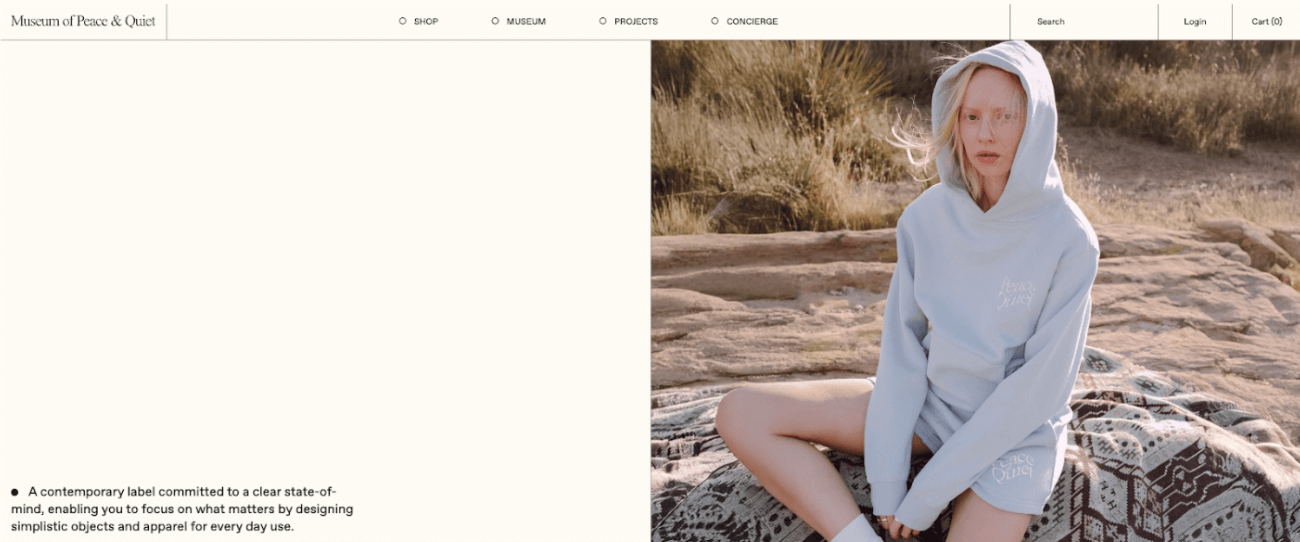 Museum of Peace &amp; Quiet homepage showing a large blank white space on the left with only three lines of text at the bottom. On the right, a hero image of a model in a light hoodie and shorts sits outdoors. The minimal design and empty space reflect the brand’s name and philosophy of simplicity and calm.